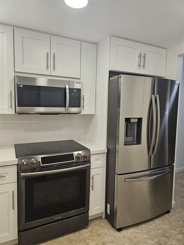 kitchen featuring white cabinetry, appliances with stainless steel finishes, and light countertops