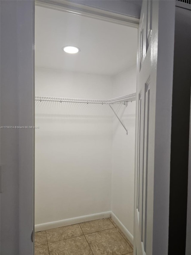 spacious closet featuring tile patterned floors