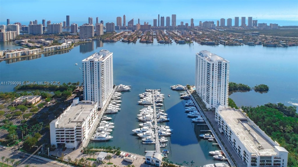 birds eye view of property featuring a view of city and a water view