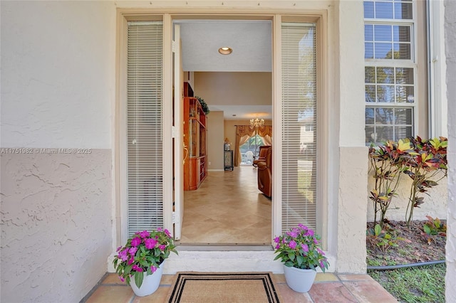 doorway to property featuring stucco siding