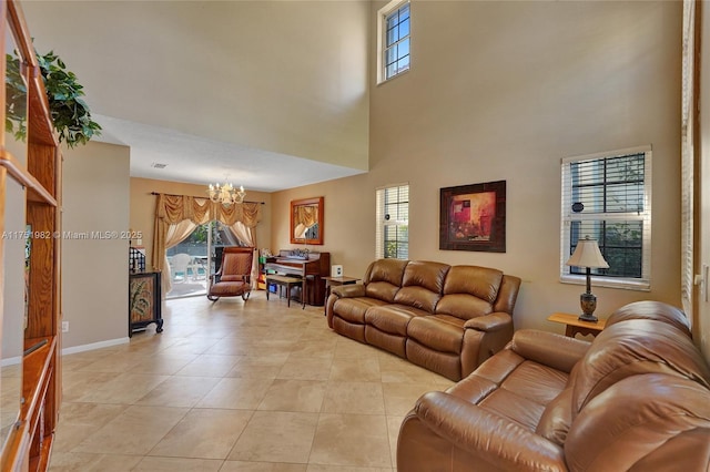 living room featuring a healthy amount of sunlight, light tile patterned floors, baseboards, and a chandelier