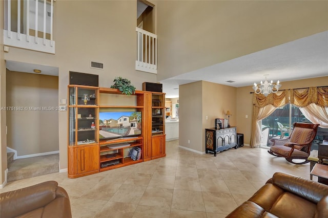 living room featuring light tile patterned floors, a notable chandelier, a towering ceiling, baseboards, and visible vents