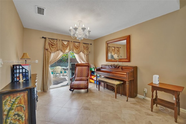 sitting room with baseboards, visible vents, a chandelier, and light tile patterned flooring