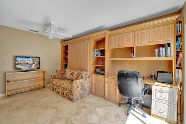 office area with ceiling fan, built in desk, visible vents, and baseboards