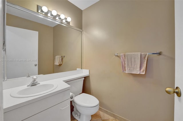 bathroom featuring toilet, tile patterned flooring, and vanity