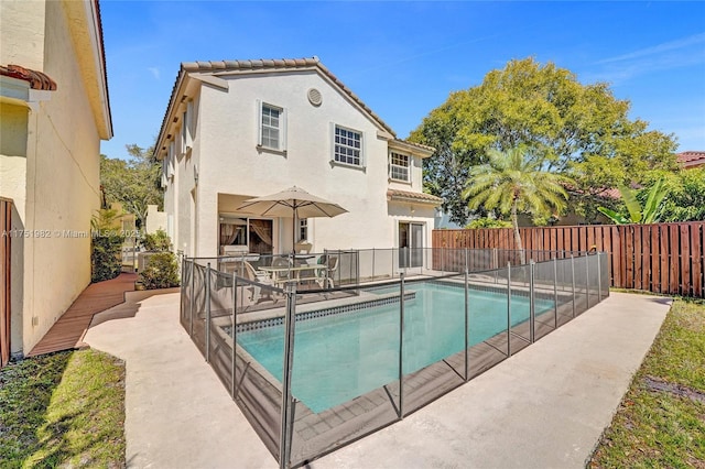 view of pool featuring a patio, a fenced backyard, and a fenced in pool