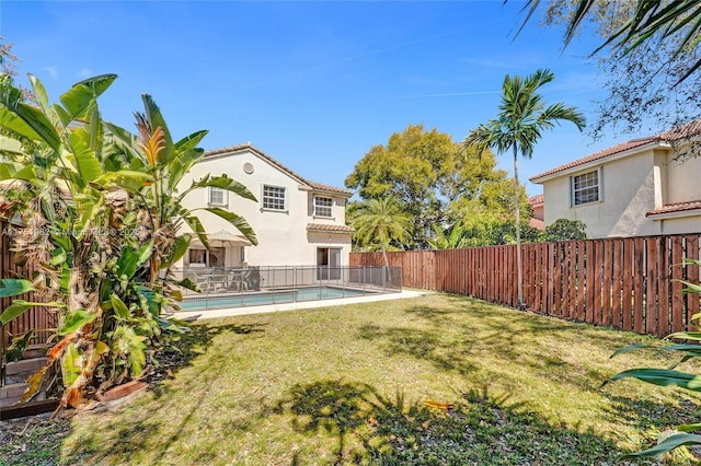 view of yard featuring a fenced in pool and a fenced backyard