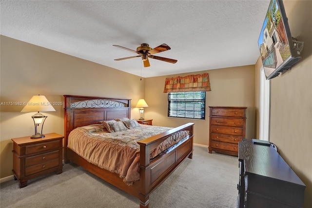 bedroom with light colored carpet, ceiling fan, a textured ceiling, and baseboards