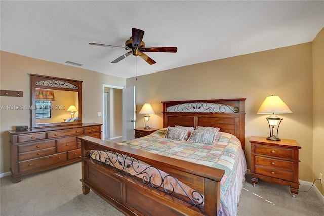 bedroom with light carpet, baseboards, visible vents, and a ceiling fan