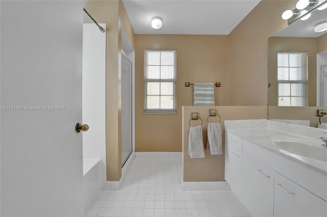 bathroom featuring plenty of natural light, walk in shower, tile patterned flooring, and vanity