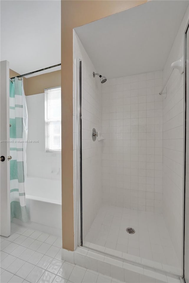 full bathroom with a tub to relax in, tile patterned flooring, and a shower with curtain