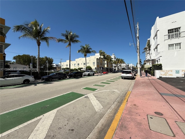 view of street with sidewalks, street lighting, and curbs