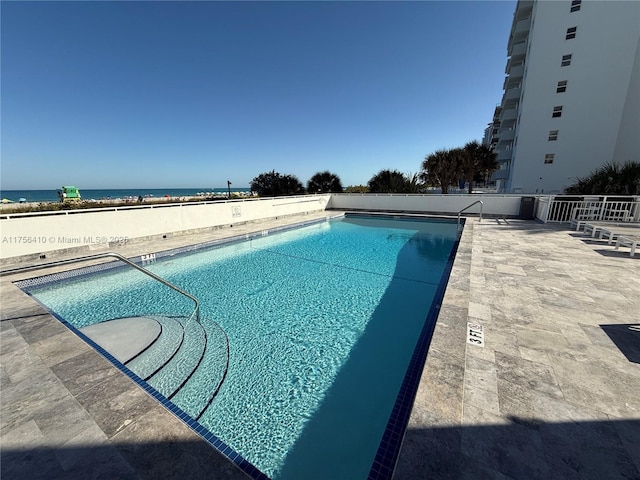 community pool with a patio area