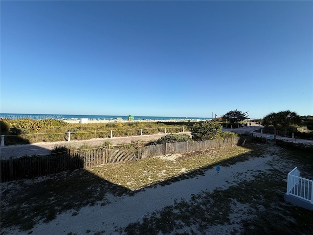 water view with a beach view and fence