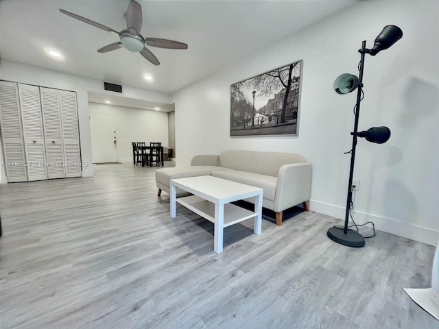 living area with recessed lighting, visible vents, a ceiling fan, wood finished floors, and baseboards