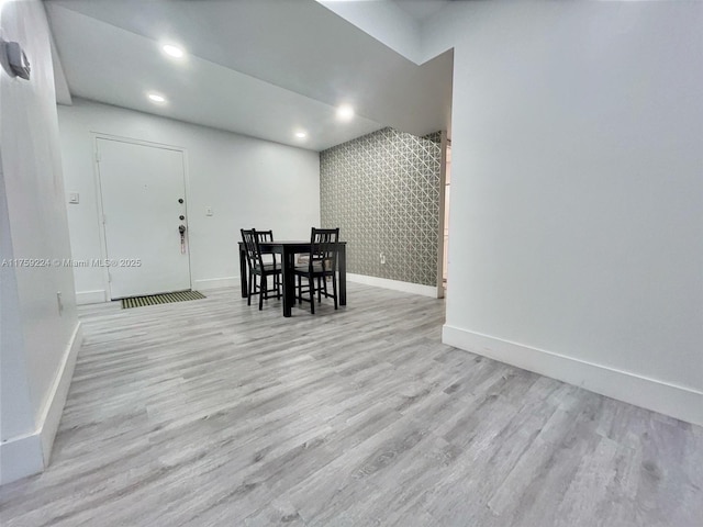 dining room featuring light wood-type flooring, baseboards, and recessed lighting