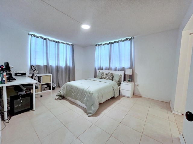 7100 NW 17th St Unit 111, Plantation, FL 33313 - bedroom featuring multiple windows, a desk, light tile patterned floors, and a textured ceiling