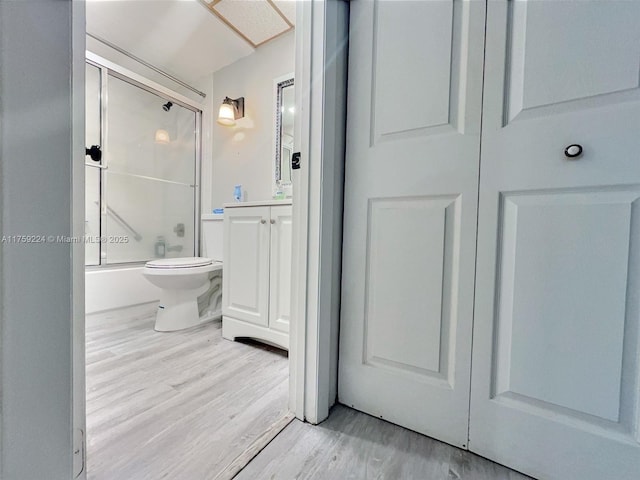 7100 NW 17th St Unit 111, Plantation, FL 33313 - full bathroom featuring wood finished floors, enclosed tub / shower combo, toilet, and vanity