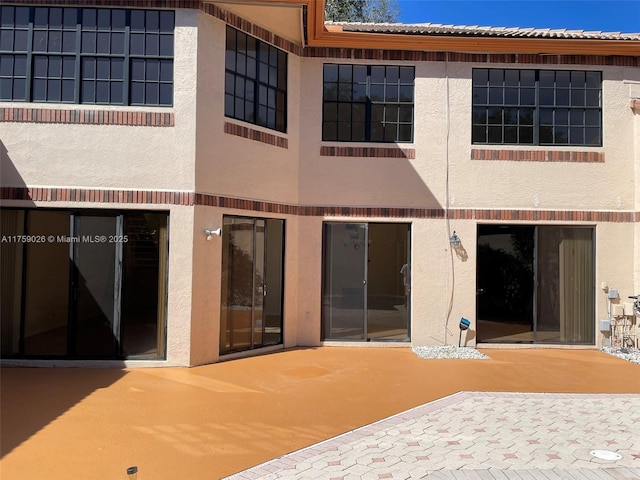 back of house featuring a patio and stucco siding