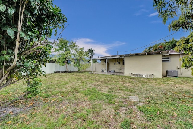 view of yard featuring a patio, a fenced backyard, and central air condition unit