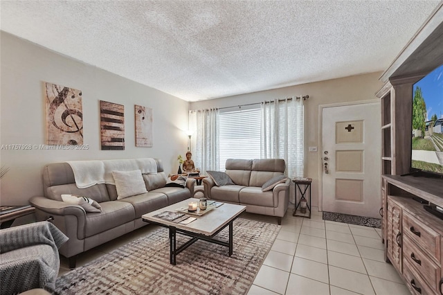 living room featuring light tile patterned floors and a textured ceiling