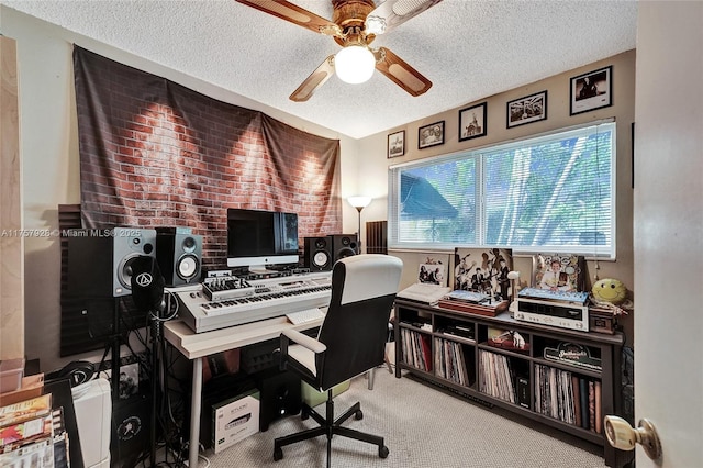 carpeted office with a ceiling fan and a textured ceiling