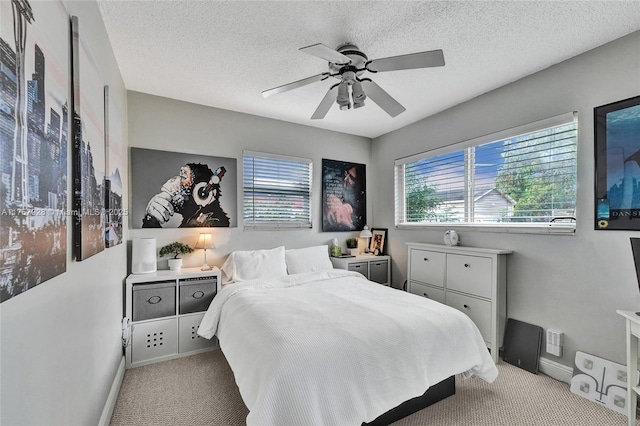 bedroom with carpet floors, ceiling fan, a textured ceiling, and baseboards