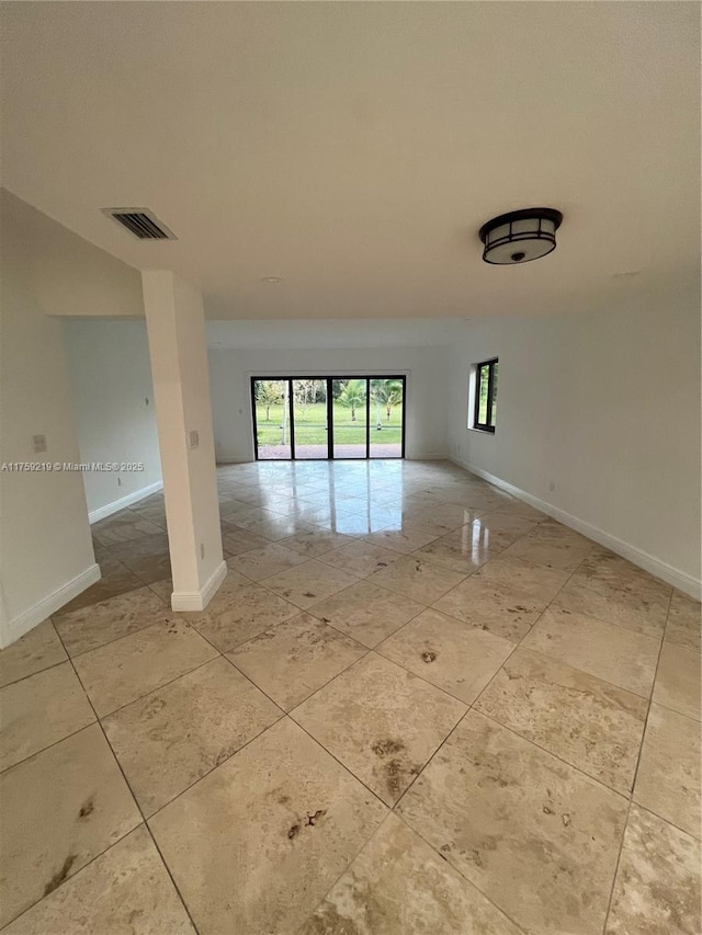 spare room featuring baseboards and visible vents