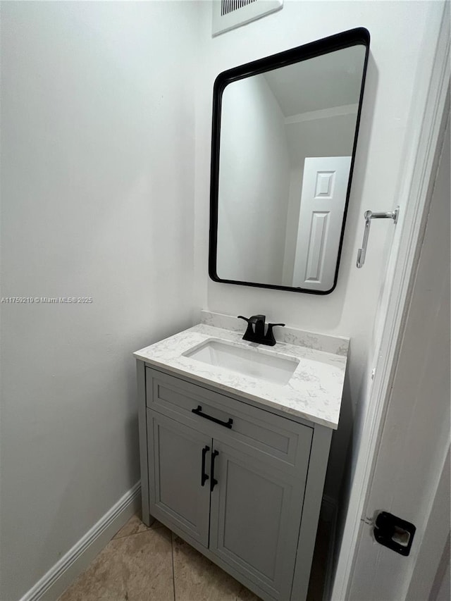 bathroom with visible vents, vanity, baseboards, and tile patterned floors