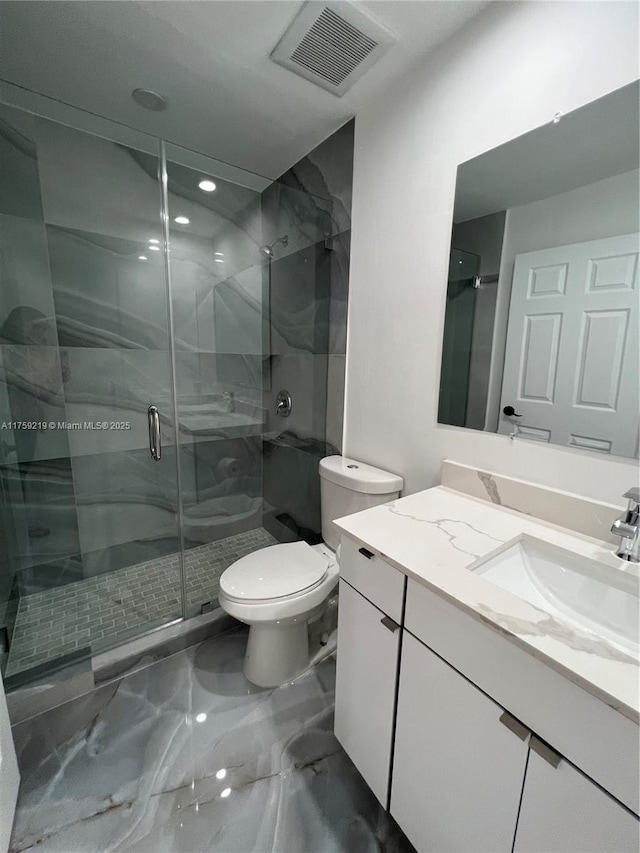 full bath featuring marble finish floor, visible vents, toilet, a shower stall, and vanity