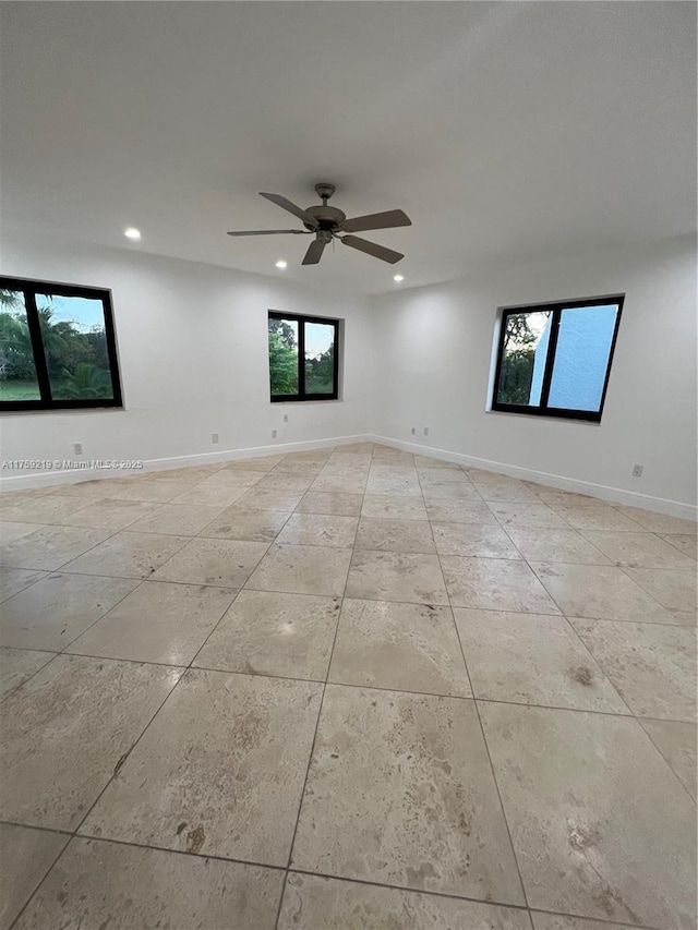 empty room with baseboards, a ceiling fan, and recessed lighting