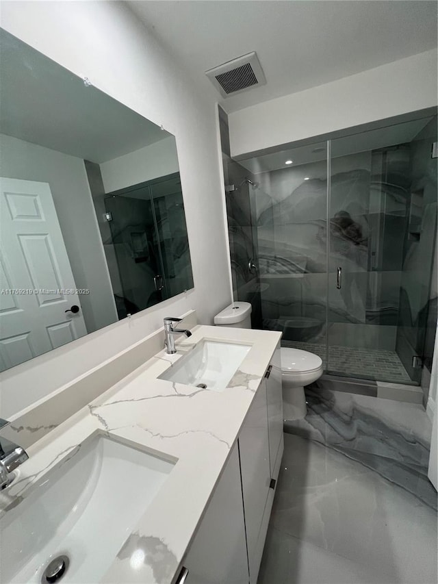 full bathroom with toilet, marble finish floor, a sink, and visible vents