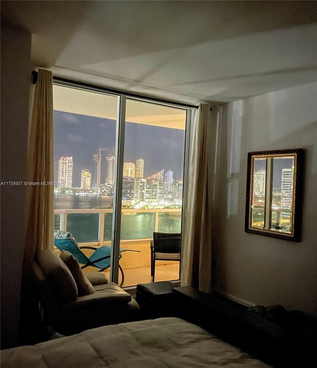 bedroom featuring a wall of windows and a city view