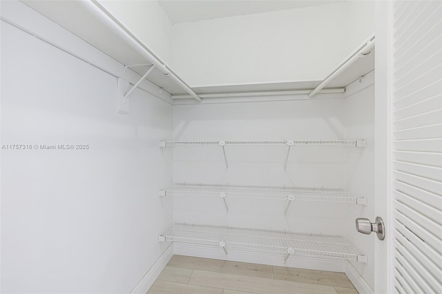 walk in closet featuring light wood finished floors