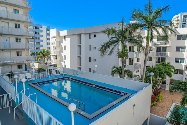 view of swimming pool featuring fence