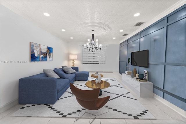 living area with visible vents, a decorative wall, a textured ceiling, and light tile patterned floors