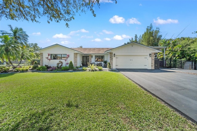 single story home with fence, a garage, stone siding, driveway, and a front lawn