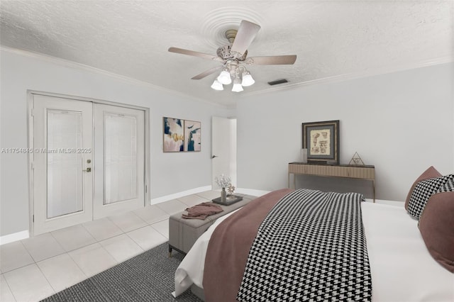 tiled bedroom with a textured ceiling, ornamental molding, visible vents, and a ceiling fan