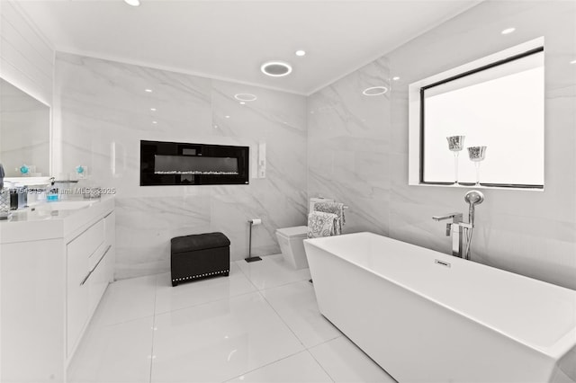 bathroom with toilet, recessed lighting, vanity, tile walls, and a soaking tub