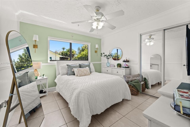 bedroom featuring ornamental molding, a textured ceiling, and light tile patterned flooring