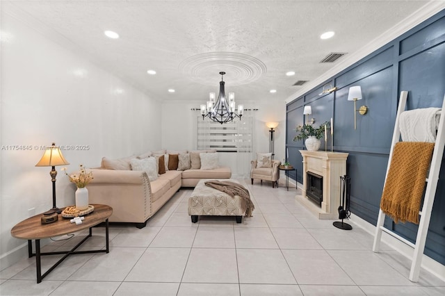 living area featuring a textured ceiling, light tile patterned flooring, a glass covered fireplace, and visible vents