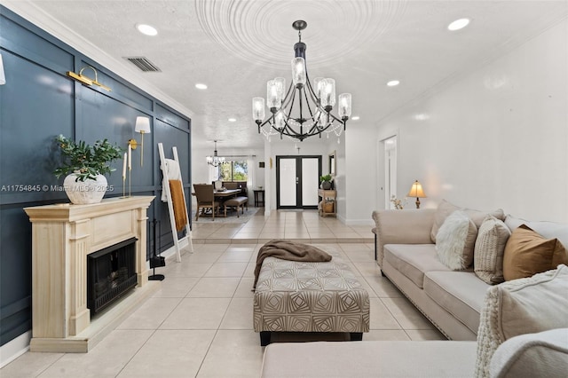 living area with light tile patterned floors, a textured ceiling, visible vents, ornamental molding, and an inviting chandelier