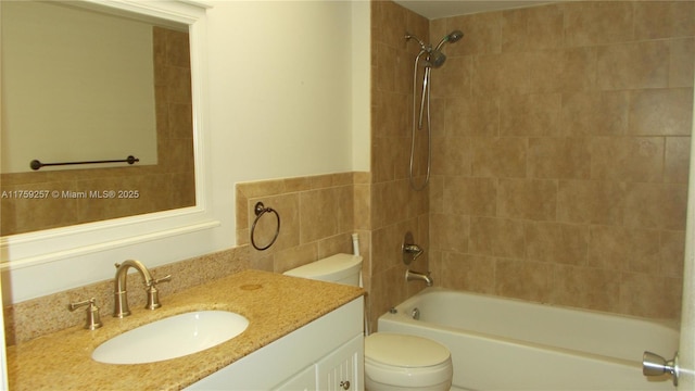 bathroom with bathing tub / shower combination, toilet, and vanity