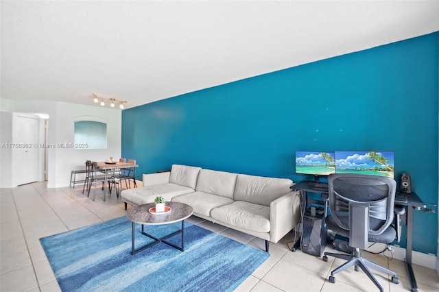 living room featuring baseboards, track lighting, and tile patterned floors