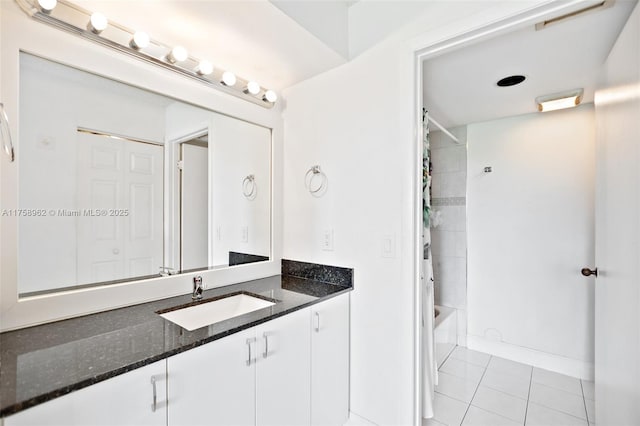 full bath with tile patterned floors, baseboards, shower / bath combo with shower curtain, and vanity