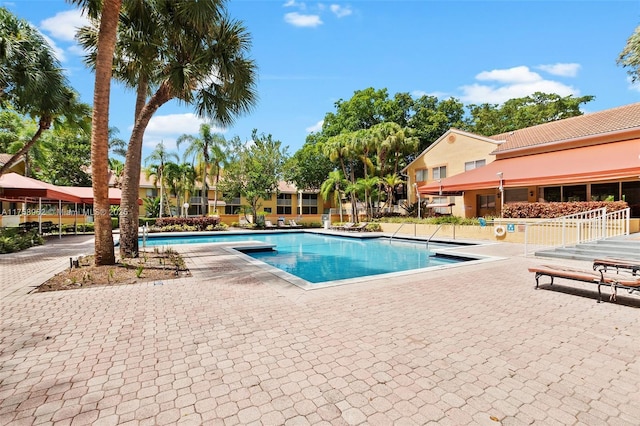 community pool with a patio area