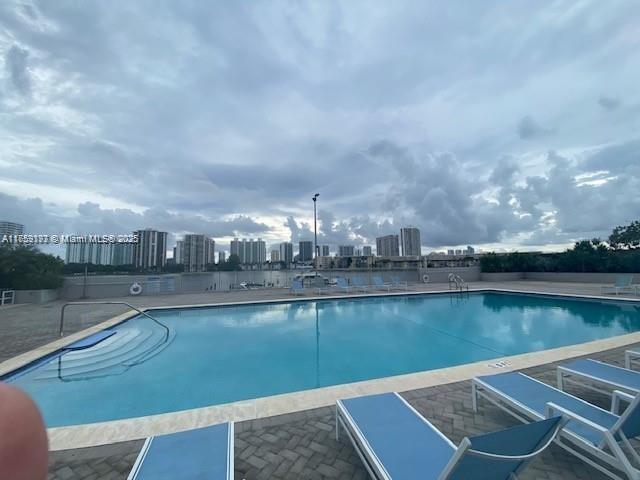 pool featuring a patio area and a view of city