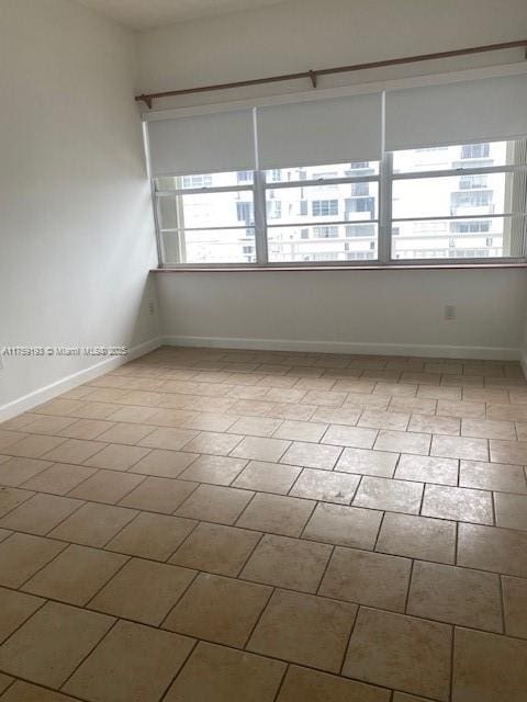 unfurnished room featuring baseboards