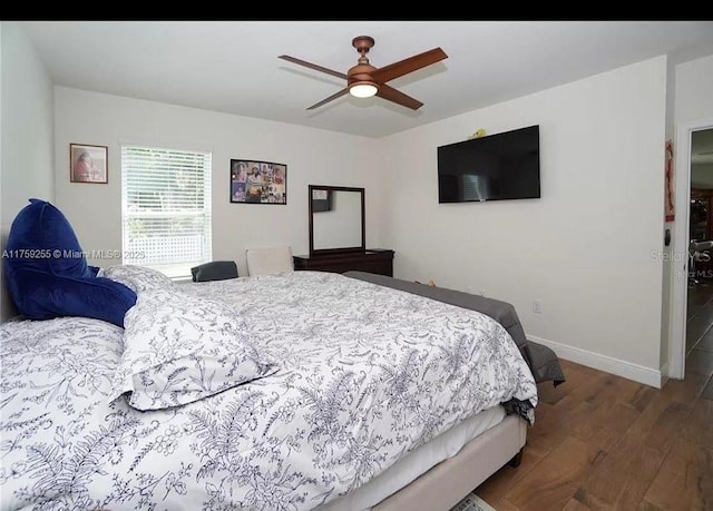 bedroom featuring ceiling fan, baseboards, and wood finished floors