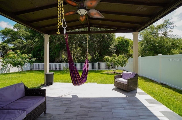 view of patio featuring ceiling fan, outdoor lounge area, and a fenced backyard